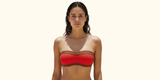 woman wearing a red and brown strapless bikini top
